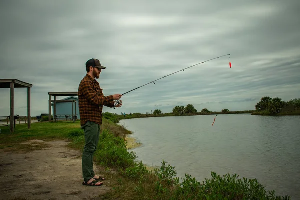 Fisherman in action Standing Up Casting — стоковое фото