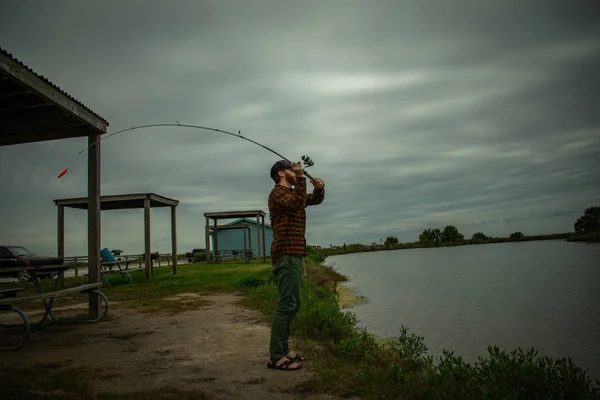 Fisherman in action Standing Up Casting — стоковое фото