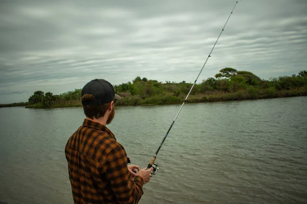 Fisherman in action Standing Up Casting — стоковое фото