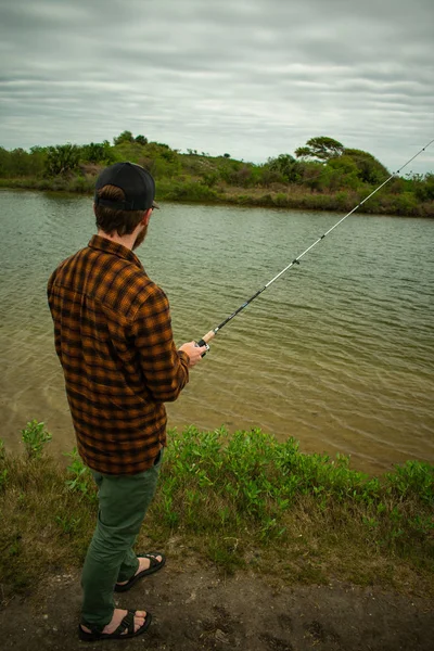 Fisherman in action Standing Up Casting — стоковое фото