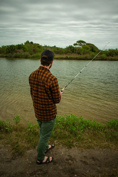 Fisherman in action Standing Up Casting — стоковое фото