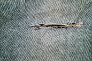 Tasarım konsepti için açık mavi kot pantolon deseninde yırtık satırı kapat