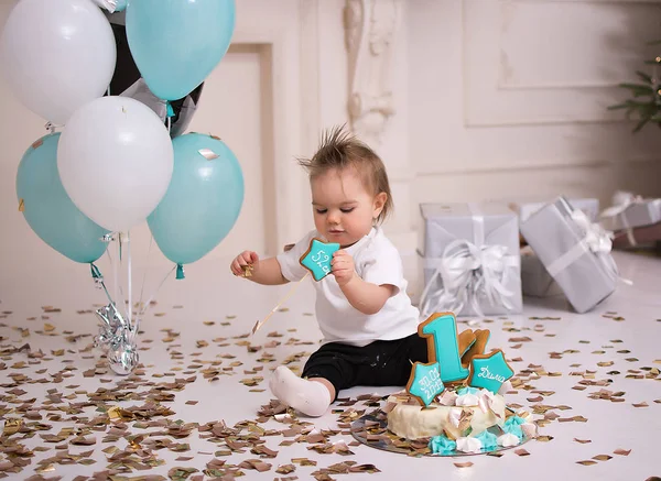 The baby is eating the first birthday cake