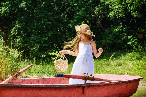 little girl in a boat on river