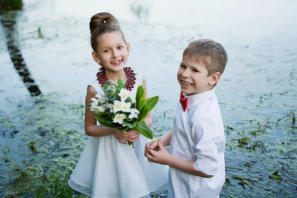 Çocuk doğada oyun. Çocuk kız çiçek verir. Doğa çocuk. Arkadaşlar