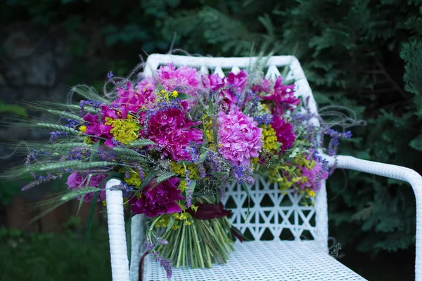 A bouquet of flowers is on the table. Flower arrangement of pink and wild flowers.
