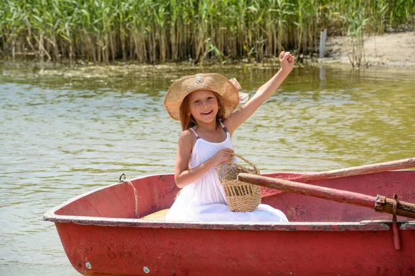 little girl on a boat. young woman in a boat.  Happy beautiful girl in a boat on the river travels