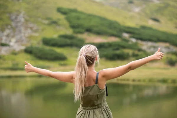 woman in the mountains. person in the mountains. Young woman showing class in the mountains