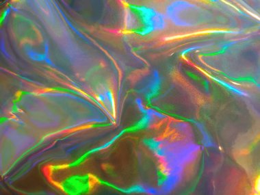 Holografik parlak gökkuşağı çok renkli gerçek buruşuk doku arkaplanı.