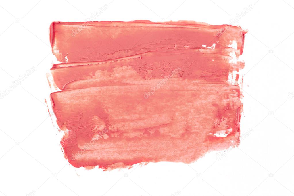 Bright beige smear of foundation in the form of a group of diagonal strokes isolated on a white background.
