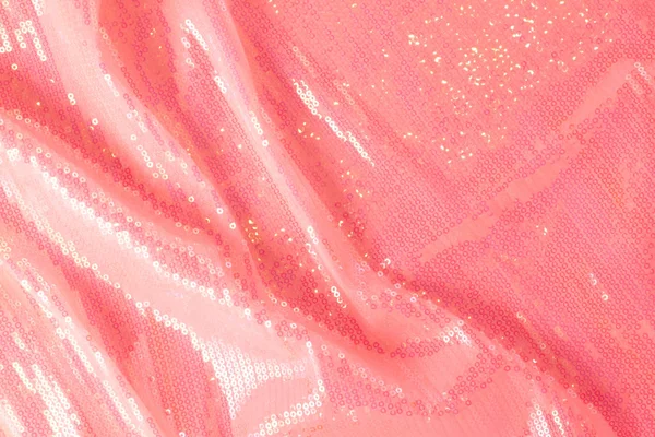 Large shiny glossy pink sequins background.