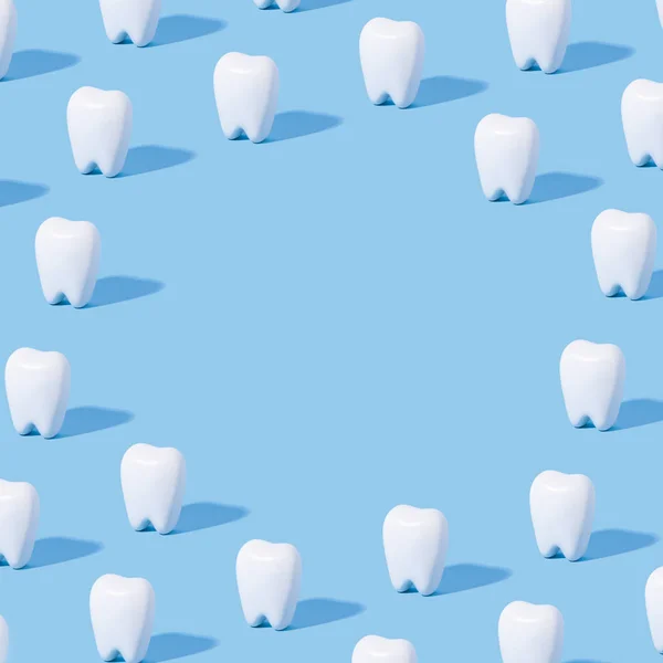 White teeth pattern on a blue paper background with text place.
