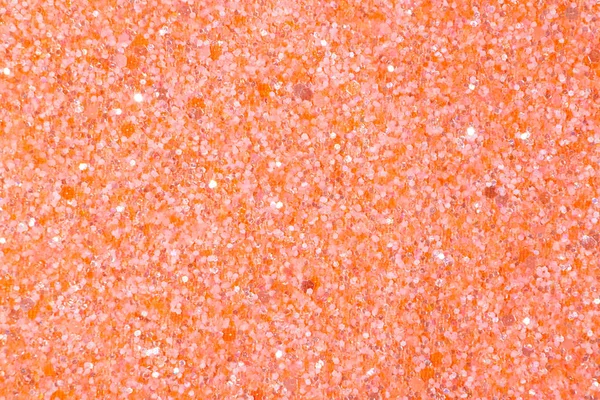 Holographic bright orange glitter texture background.
