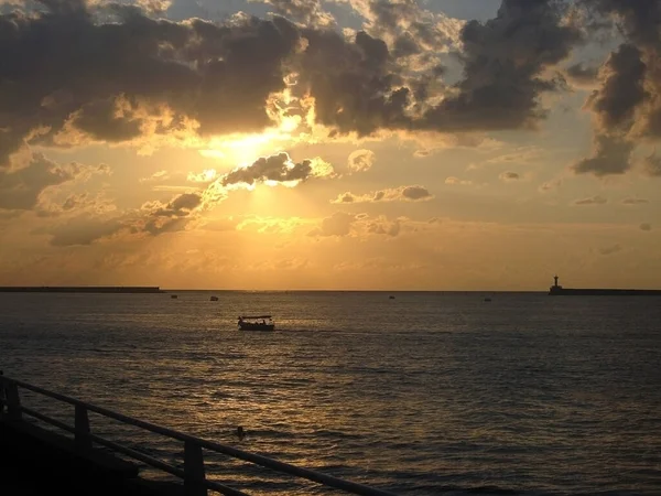 Gün batımında deniz, turuncu gökyüzü, yansıma