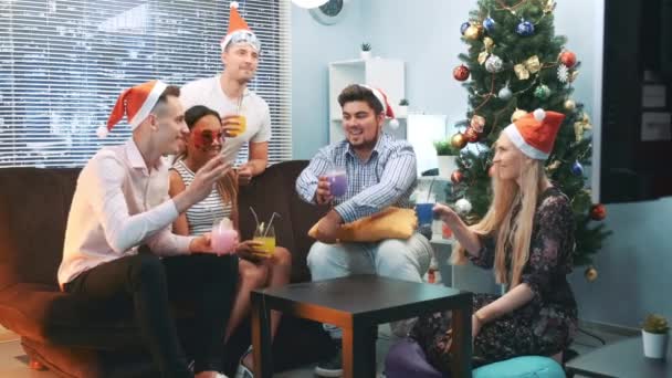 Happy New Years celebration in cheerful company in Santa hats and party masks — Stock Video