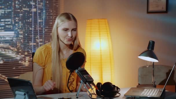 Close-up of female poet reading her poem into the microphone in home recording studio — Stock videók