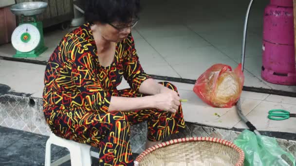 Vendedor en el mercado callejero en el casco antiguo de Hanoi Vietnam. Mujer vestida con lechuga verde vendedora para comer en la calle . — Vídeo de stock