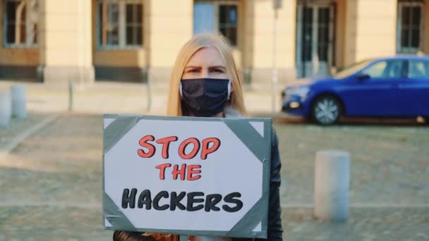 Concerned woman with protest banner calling to stop hackers — Stock Video