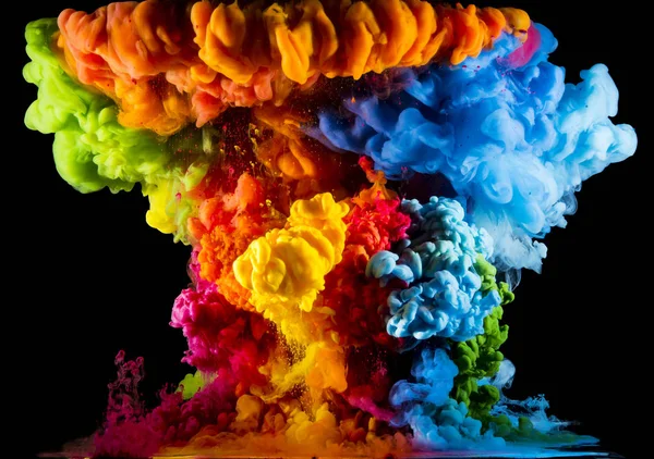 Colorful paint drops from above mixing in water. Ink swirling underwater