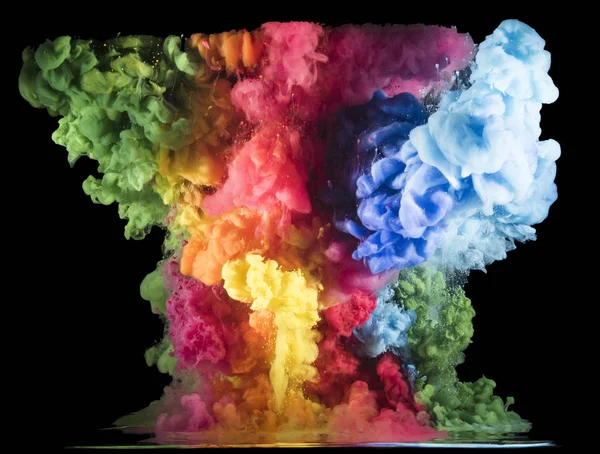 Colorful paint drops from above mixing in water. Ink swirling underwater.