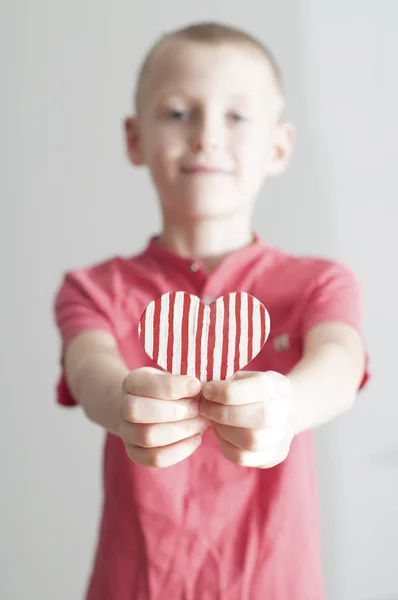 Happy Boy Giving Red Stripped Heart Shape His Mom White — Stock Photo, Image