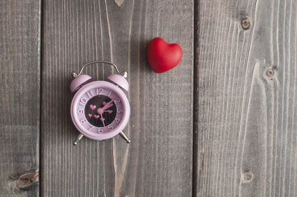 時は愛です バレンタイン ピンク アラームの心と形の木製の背景上のシンボル — ストック写真
