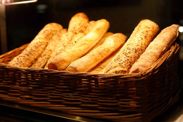 Basket with bread sticks on bakery counter — Stock Photo, Image