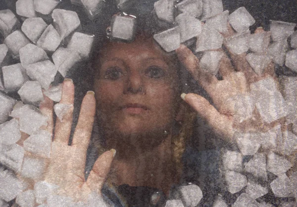 A woman under the ice. Woman portrait.