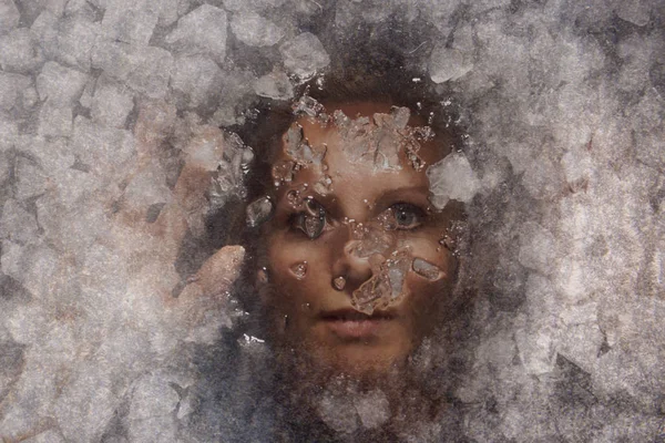 A woman under the ice. Woman portrait.