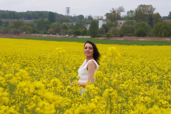A girl in a yellow flower field, a beautiful spring landscape, a bright sunny day, canola. Cool