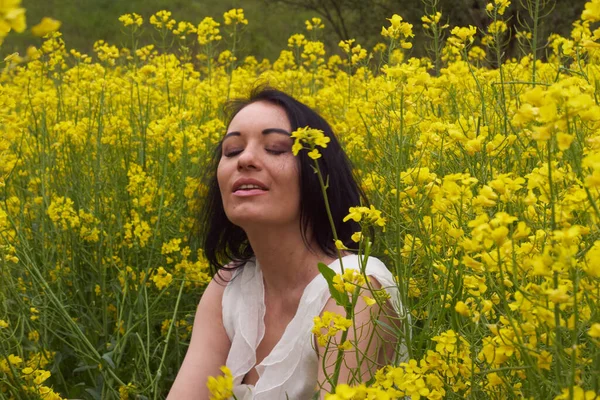 A girl in a yellow flower field, a beautiful spring landscape, a bright sunny day, canola. Cool