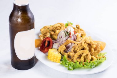 peruvian food: ceviche de pescado con calamar con cerveza