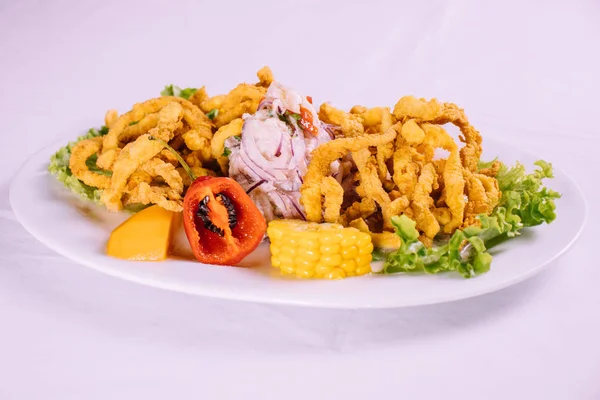 peruvian food: ceviche de pescado con calamar