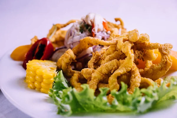 peruvian food: ceviche de pescado con calamar