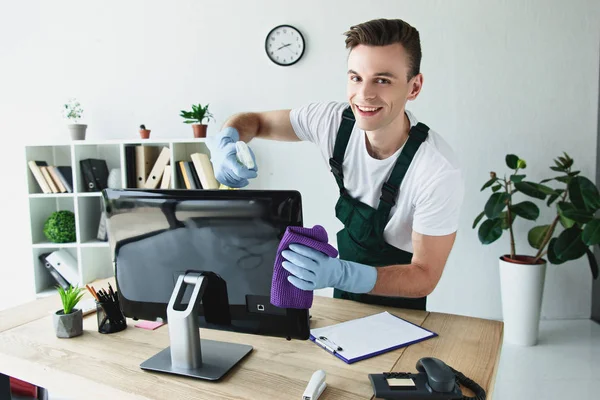 Handsome Young Cleaner Rubber Gloves Cleaning Computer Monitor Smiling Camera — Stock Photo, Image