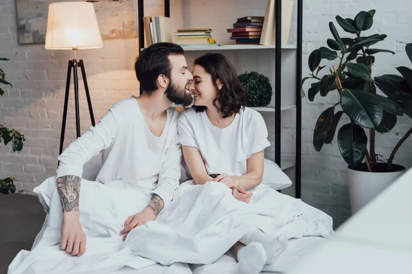 Handsome Bearded Man Biting Nose Smiling Woman Home Bed — Stock Photo, Image