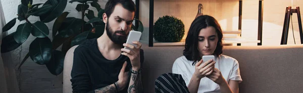 Focused Young Couple Sitting Couch Using Smartphones Living Room — Stock Photo, Image