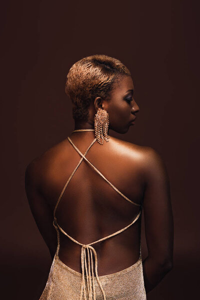 back view of attractive african american woman with short hair isolated on brown