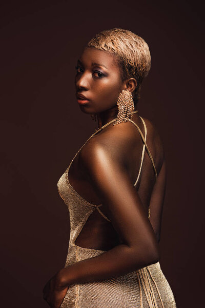 beautiful fashionable african american girl with short hair isolated on brown