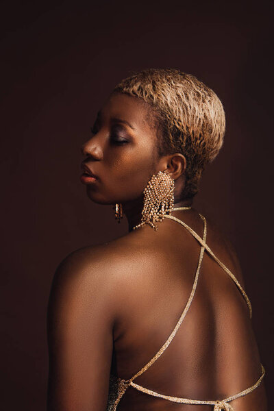 beautiful african american model with short hair isolated on brown