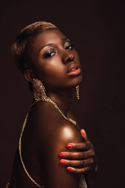 beautiful african american woman with short hair isolated on brown