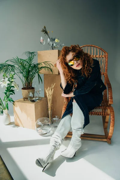 Stylish Redhead Girl Sunglasses Wicker Chair Wooden Boxes Glasses Plants — Stock Photo, Image