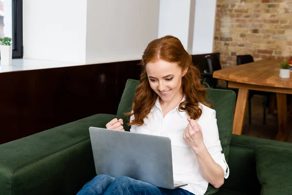 Smiling Freelancer Showing Yeah Gesture While Using Laptop Living Room — Stock Photo, Image