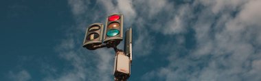 Panoramic shot of traffic lights with cloudy sky at background  clipart
