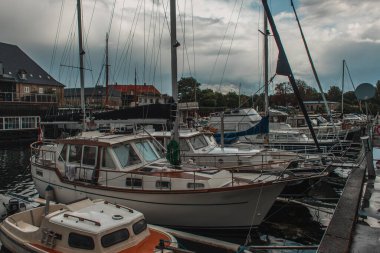 Boats in harbor with cloudy sky at background in Copenhagen, Denmark  clipart
