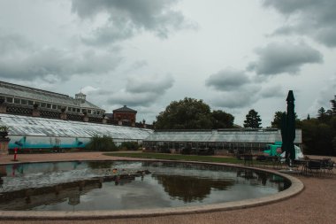 Pond with botanical garden and cloudy sky at background in Copenhagen, Denmark  clipart