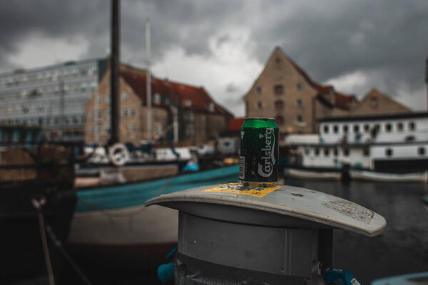 COPENHAGEN, DENMARK - APRIL 30, 2020: Selective focus of can of carlsberg beer on urban street