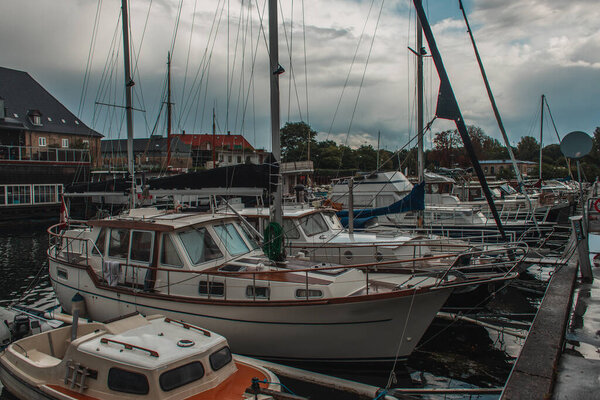 Boats in harbor with cloudy sky at background in Copenhagen, Denmark 