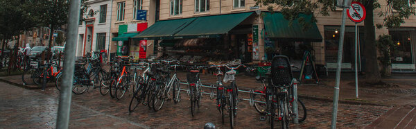 Panoramic crop of row of bicycles on urban street in Copenhagen, Denmark 