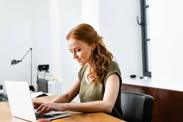 Selektiver Fokus attraktiver Telearbeiter mit Laptop am Tisch — Stockfoto